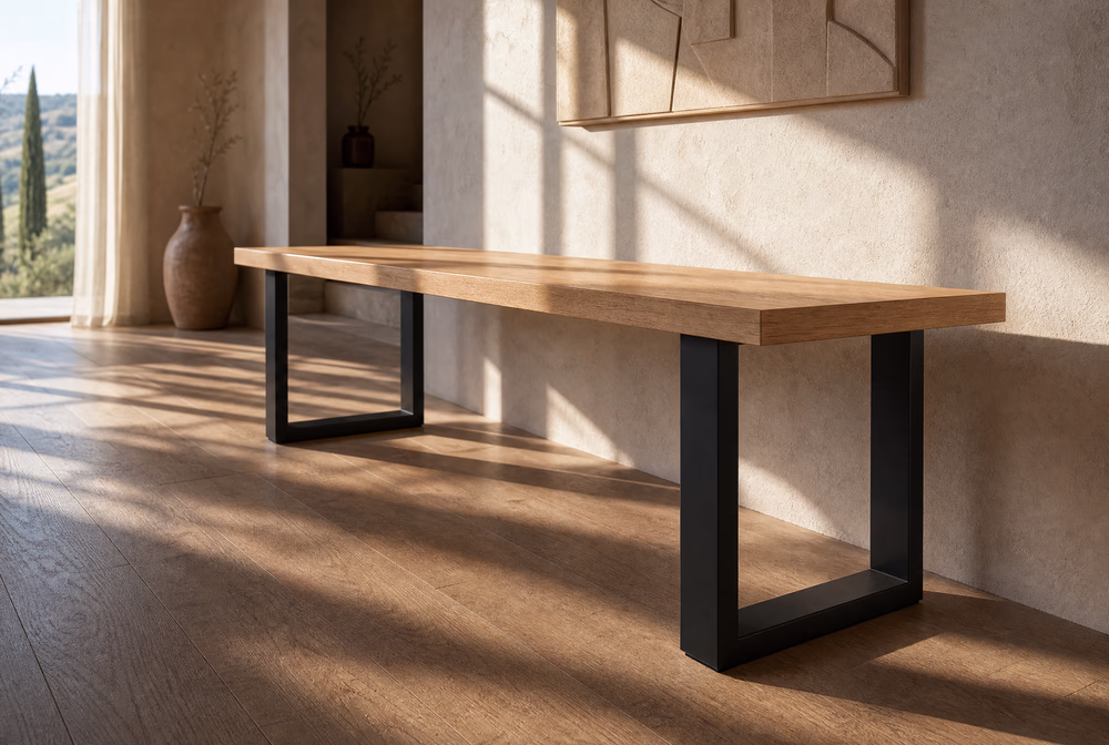 The oak bench along the wall with long window shadows across it.